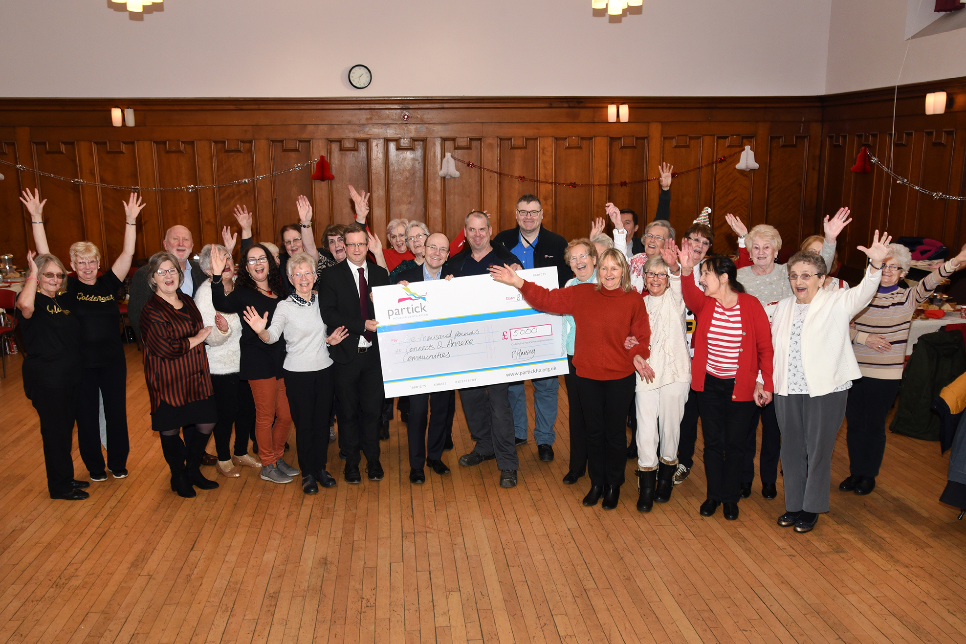 Partick Housing Association and partners present cheque for £5,000 at Christmas tea dance